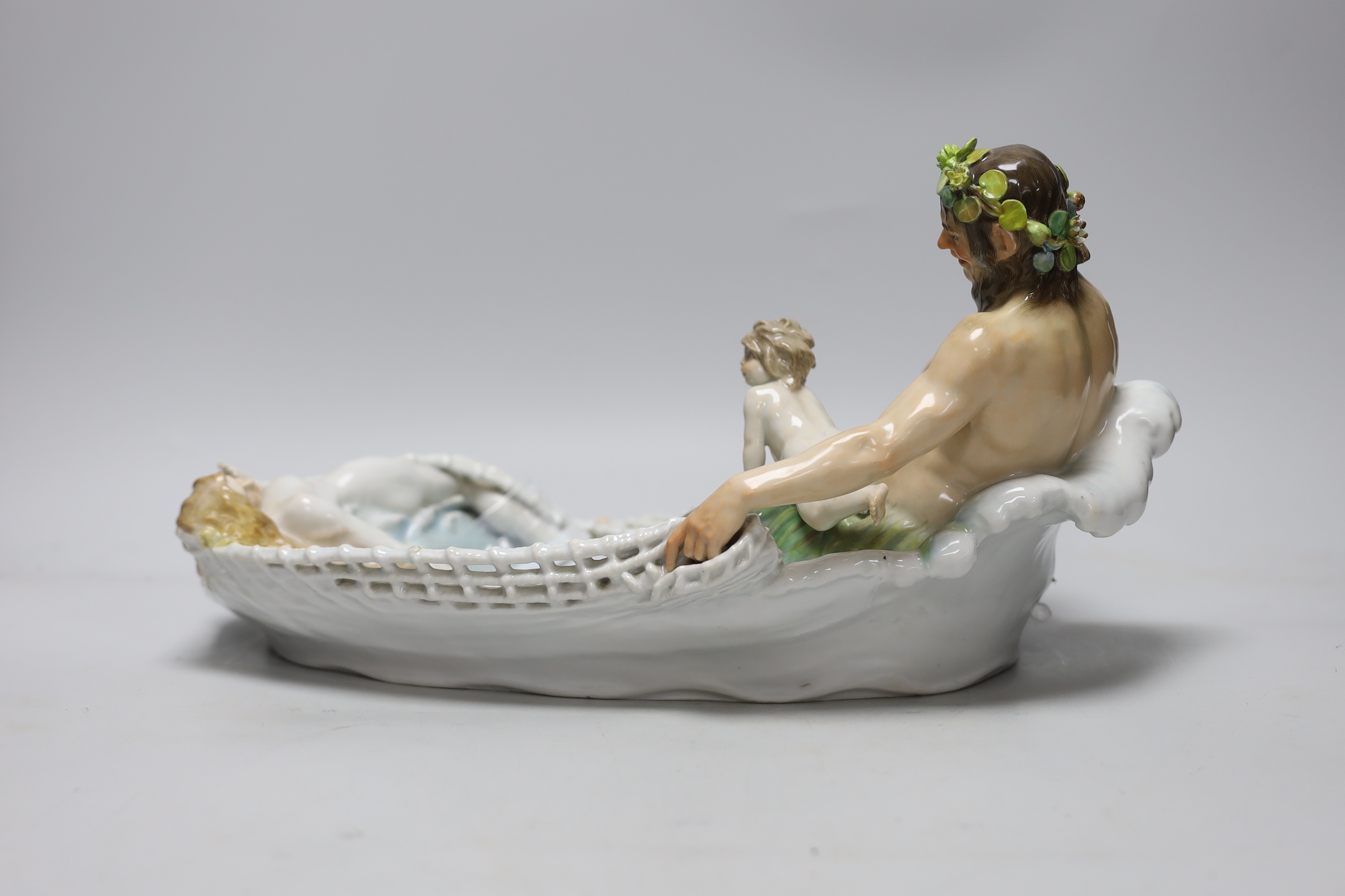 A Meissen group of Triton netting a nymph, early 20th century, modelled by T P Helmig, (a.f.), 38cm long